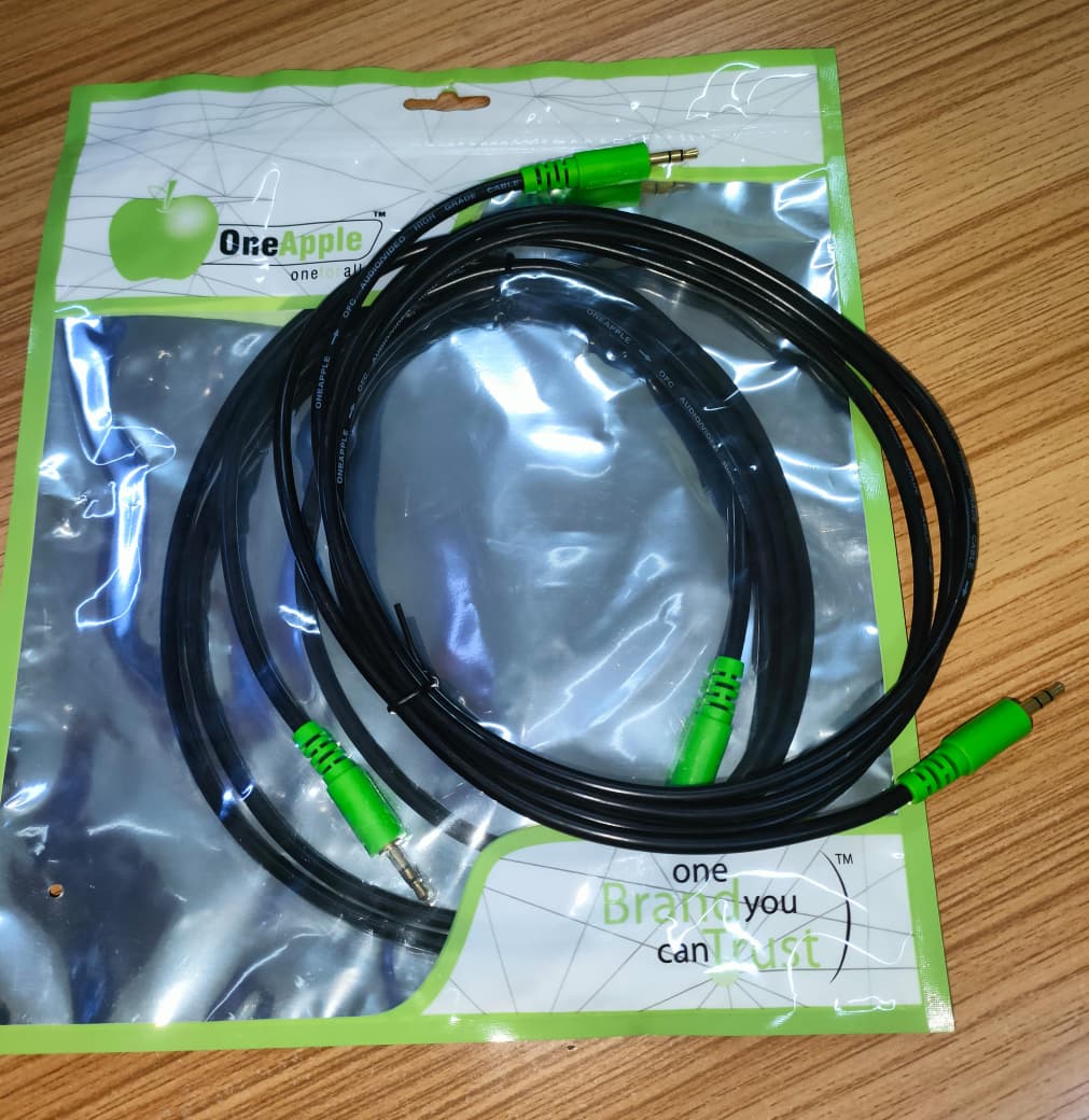 Aux cable in packaging with green connectors visible